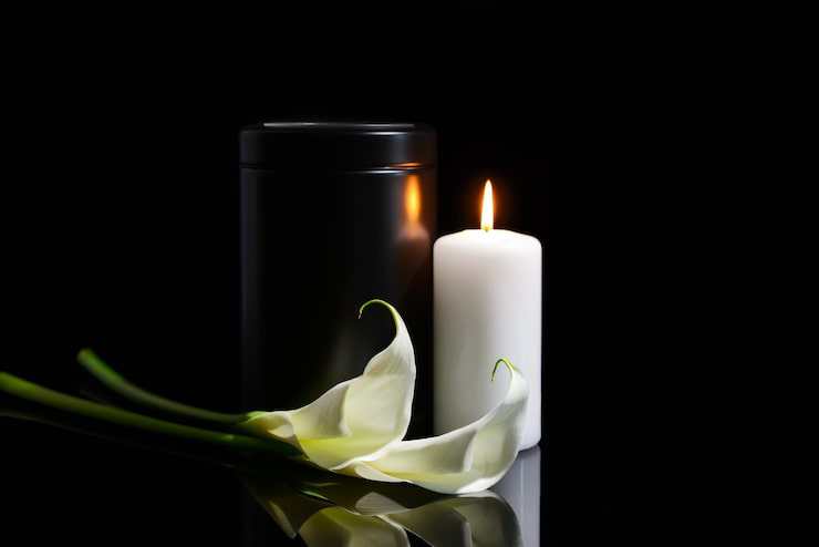 burning-candle-with-lily-and-urn burning-candle-with-lily-and-urn