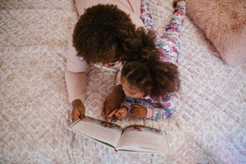 mother-and-daughter-reading-book-together